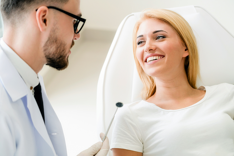 lady smiling and talking with the dentist