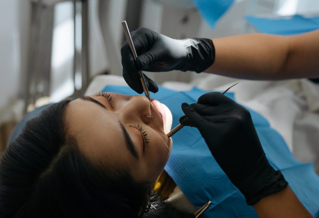 lady having her teeth cleaned at the dentist